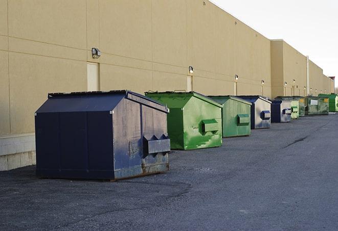 a row of construction dumpsters parked on a jobsite in Baldwin City